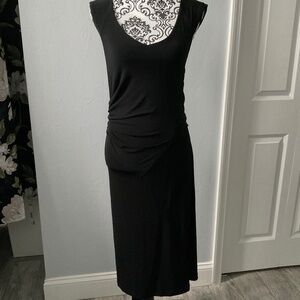 Sleeveless black dress with  attached belt to make bow.